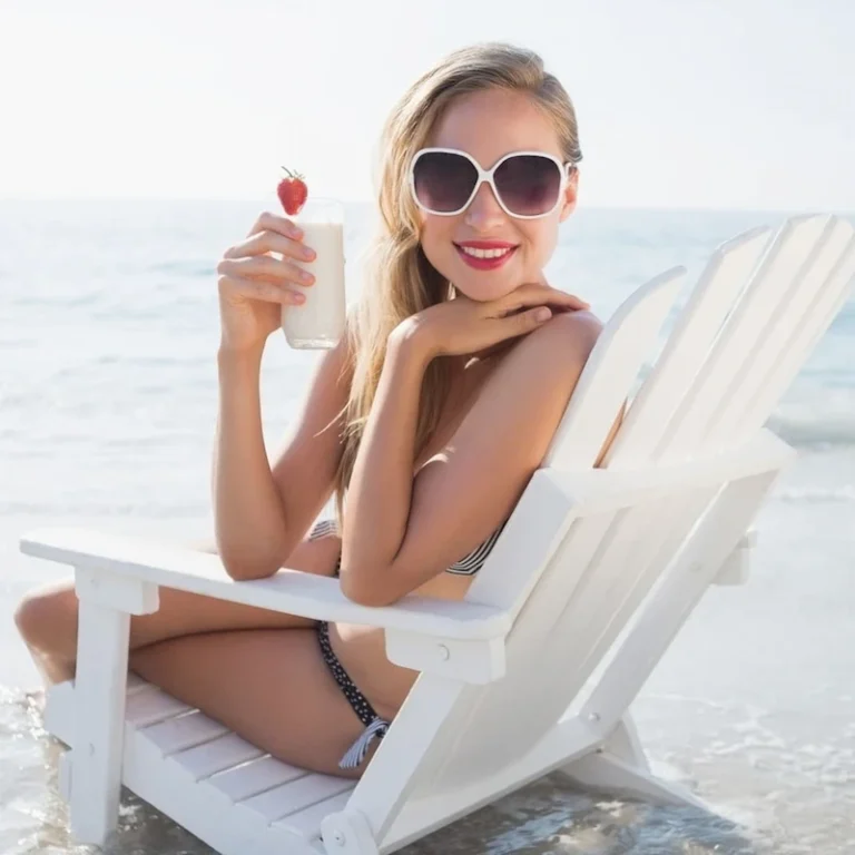 Woman-enjoying-the-beach-with-a-drink-768x768