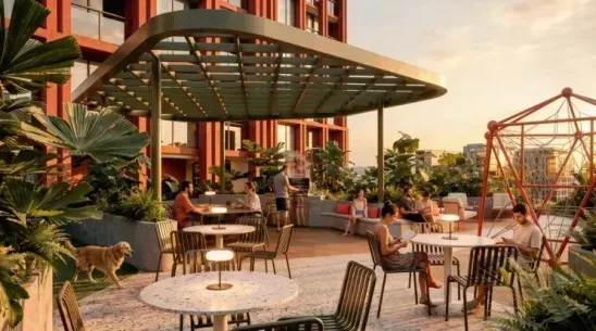 playground The Playground terrace at sunset, with a tensile canopy over café tables, a red climbing frame, lounge seating and a dog under tropical planting